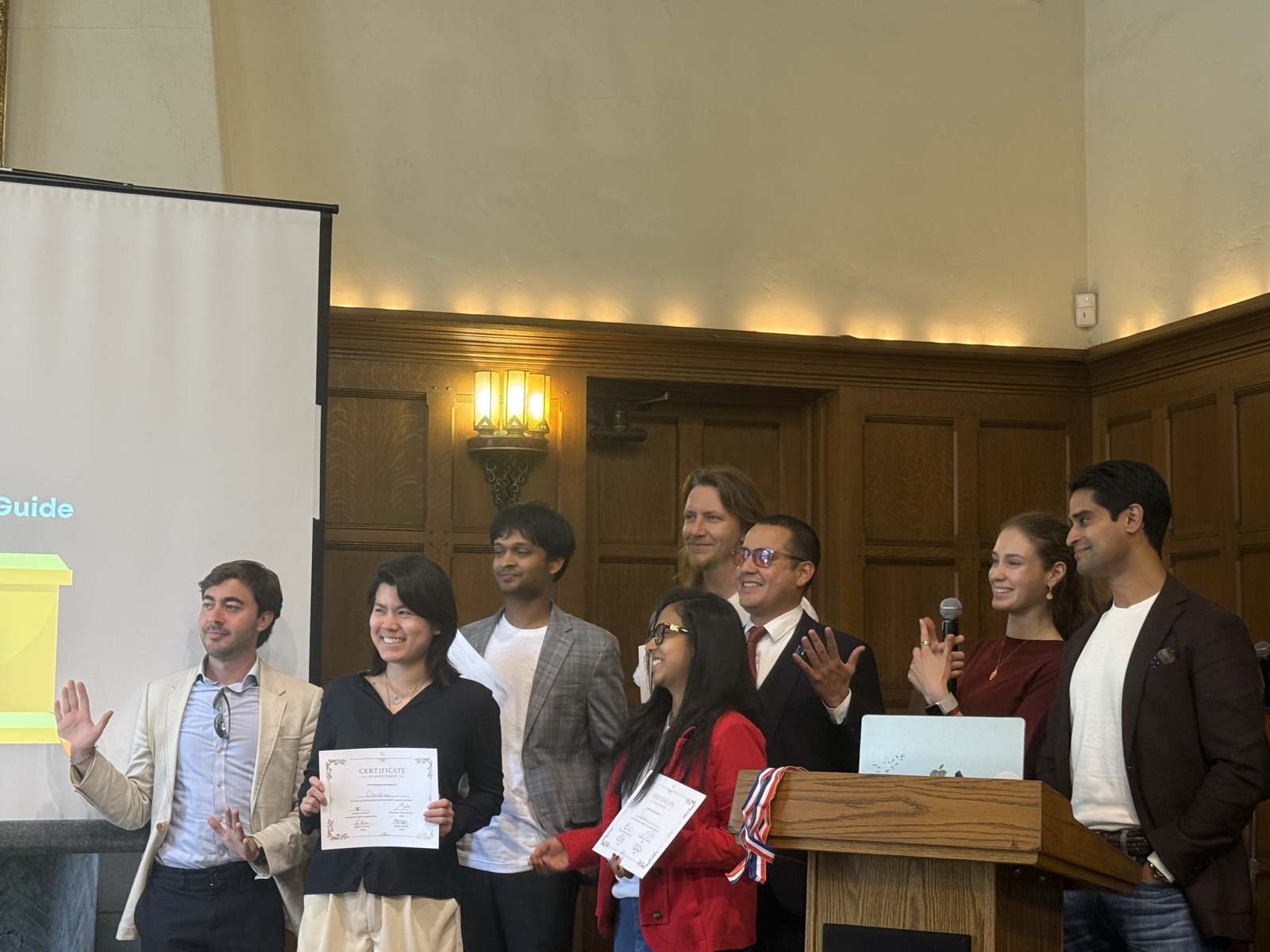 Hackathon winners receiving certificates on stage